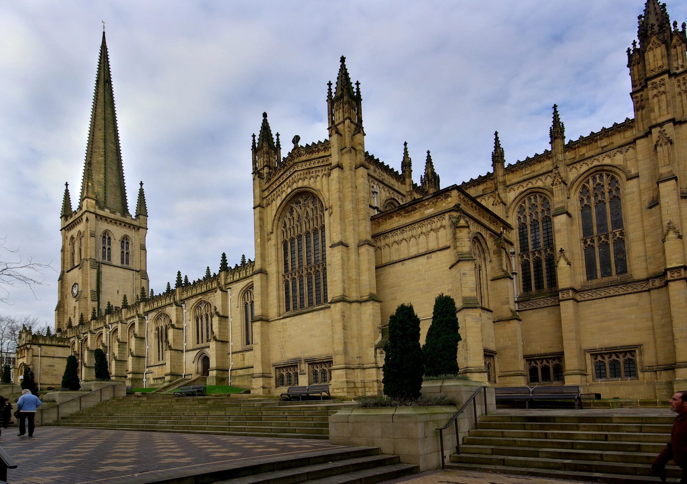 Wakefield Cathedral spire and east end seen from the precinct steps under an overcast sky