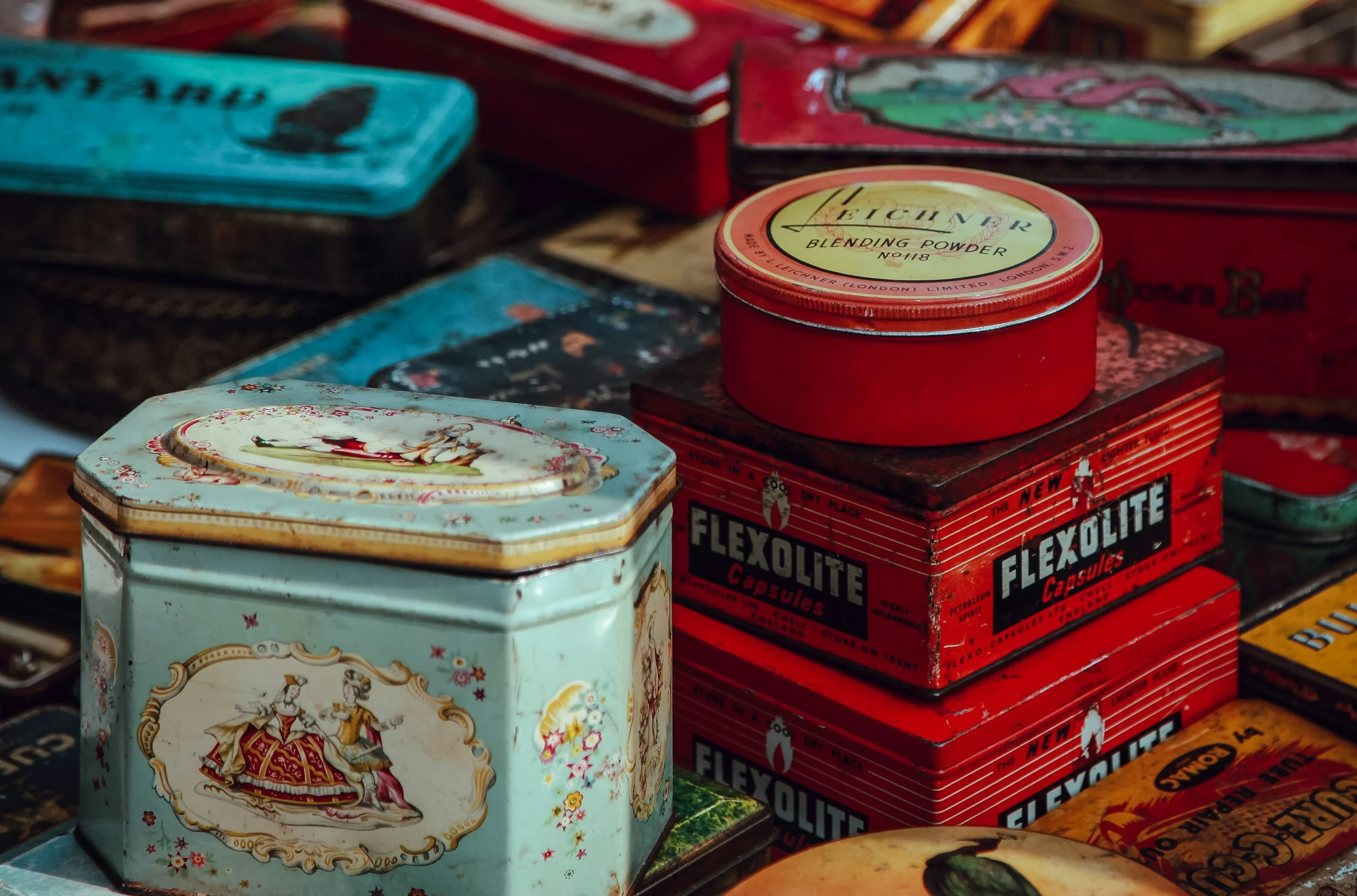Pile of old British tins, including a tea caddy